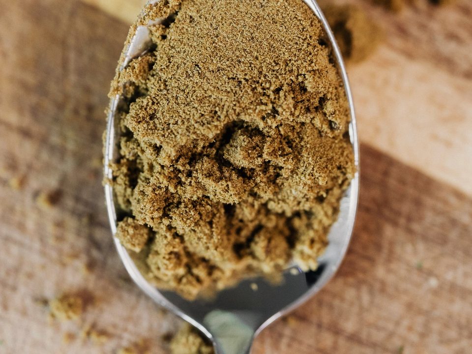 Ginger powder, a buff fine powder on a metal spoon