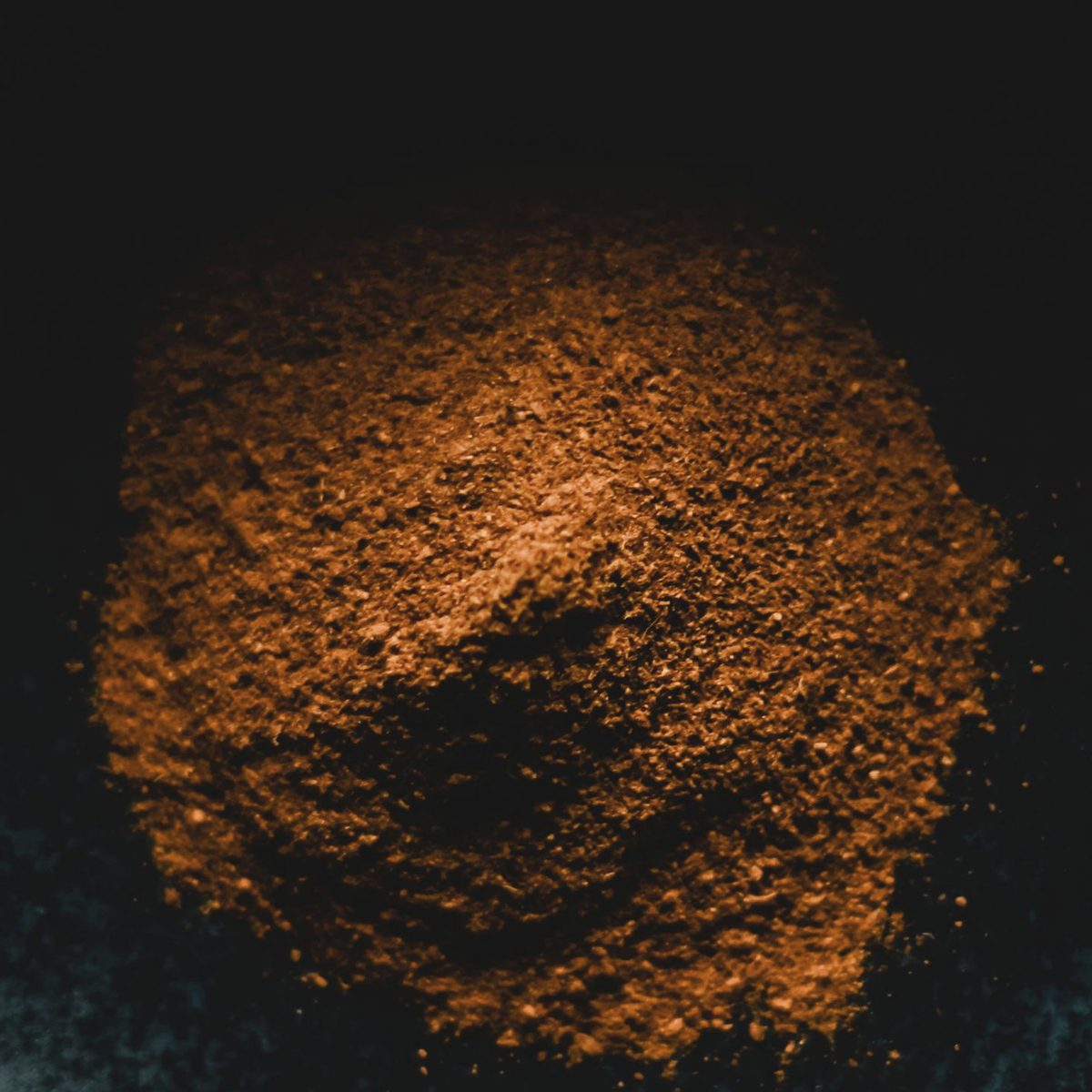 Jamun seed extract, a light to mid brown fine powder in a dark bowl
