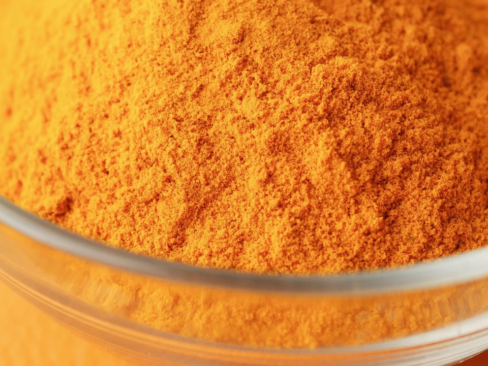 Turmeric extract standardised to 95% curcuminoids, an orange-yellow powder in a glass bowl